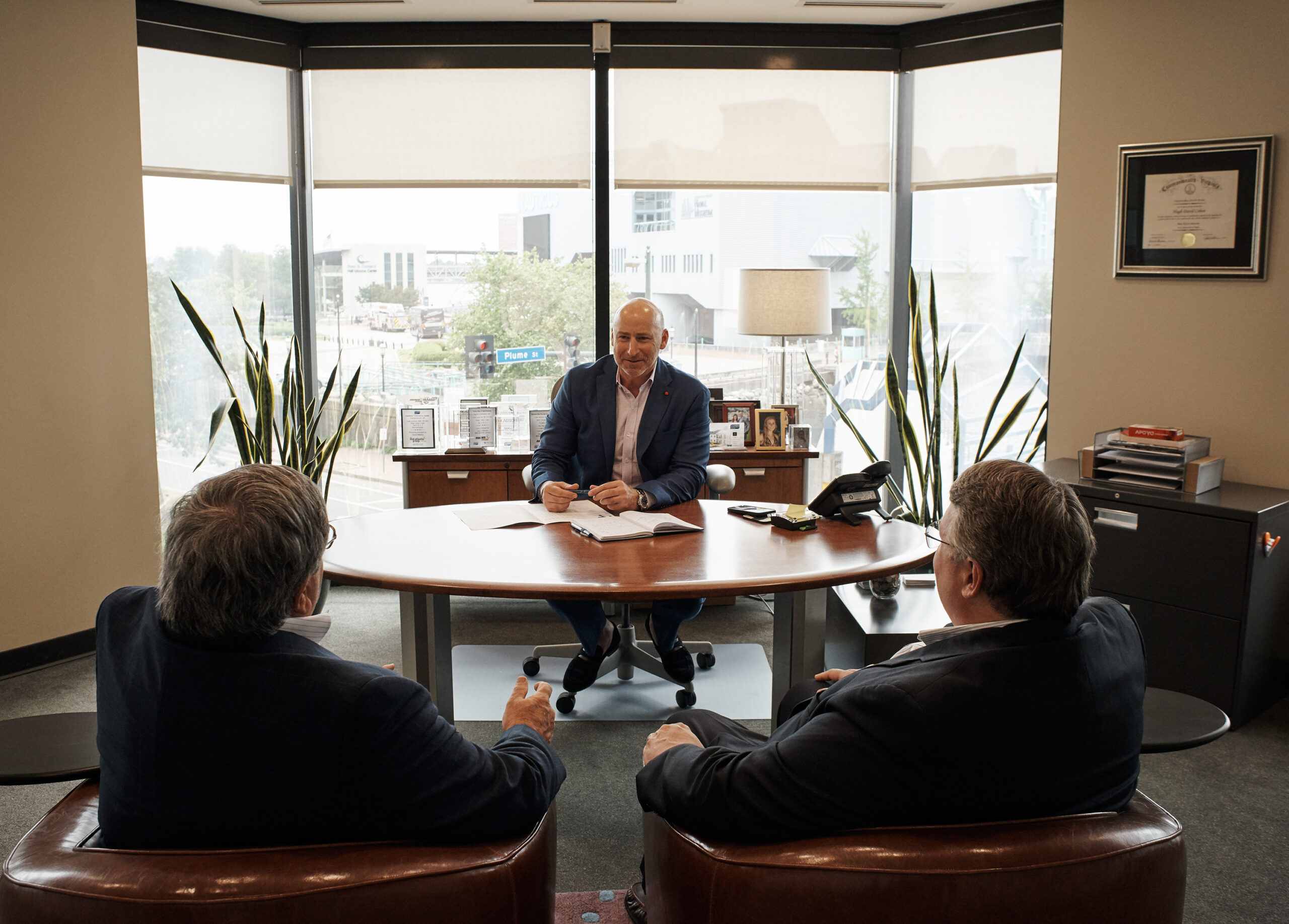 Hugh Cohen and the CIG partners talking around a desk.